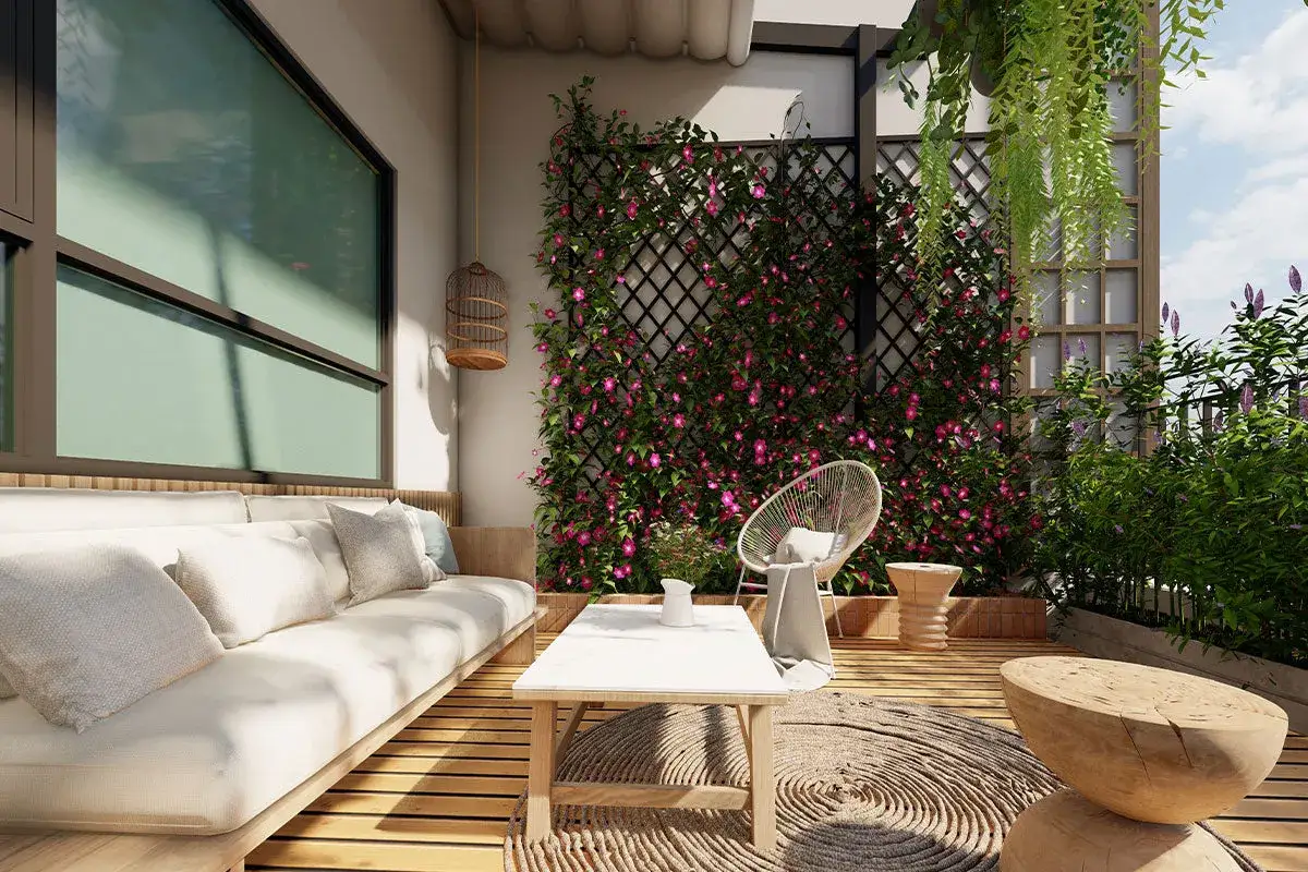 Un divano comodo e un tavolino invitano al relax su questo terrazzo fiorito. Idee terrazzo per un angolo verde e accogliente.