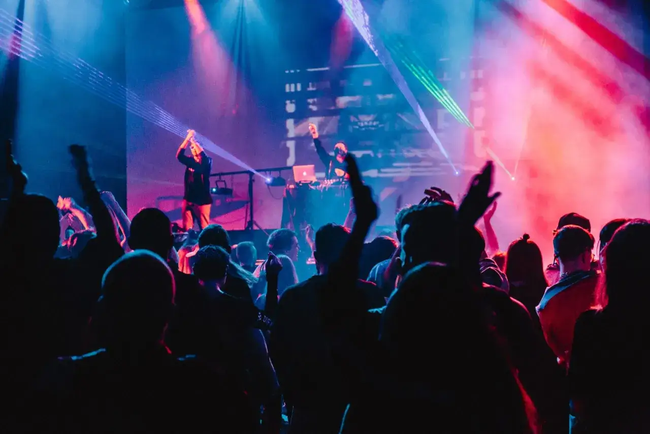 Eine Menge feiert zu A&R Music bei einem Konzert mit Lasershow.