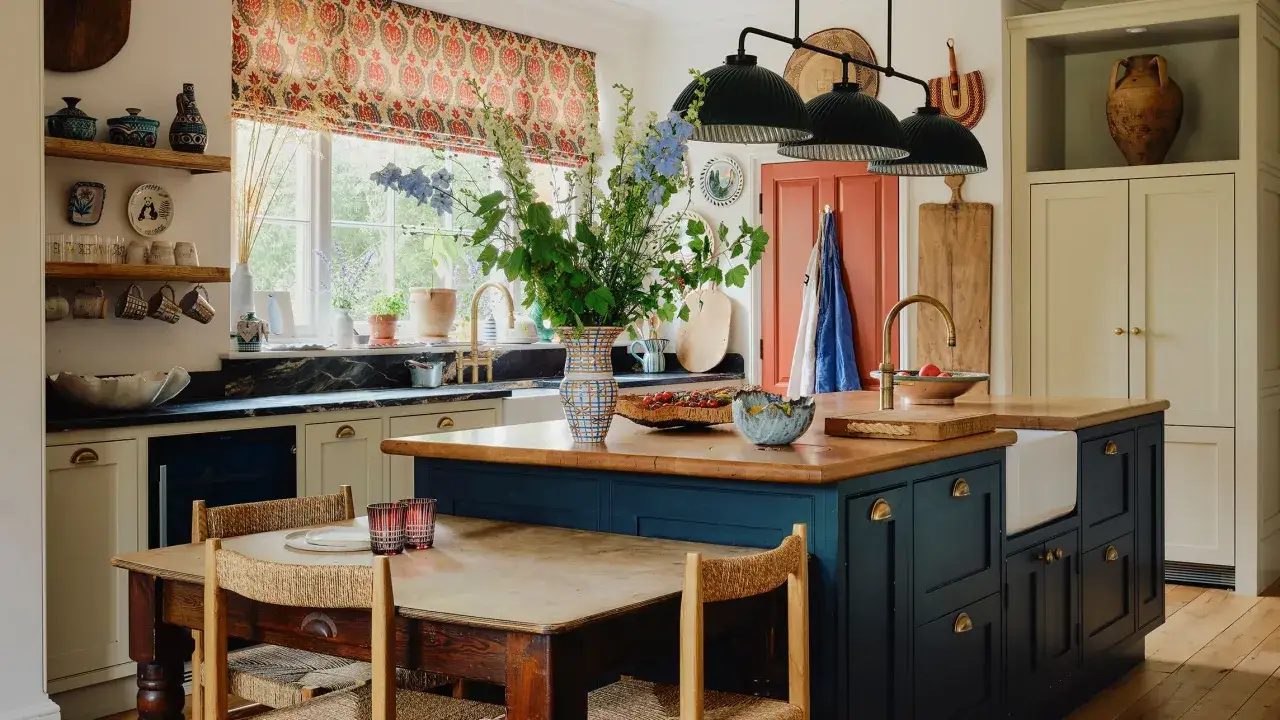 A charming kitchen island with a farmhouse sink and brass faucet, surrounded by a rustic wooden table and chairs. This space embodies latest kitchen designs with its blend of traditional and modern elements.