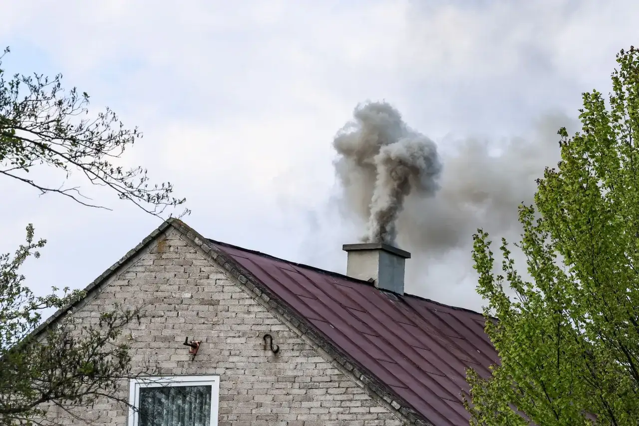 Gęsty dym z komina domu. Kto pobiera opłaty za emisję CO2, gdy takie widoki stają się codziennością?