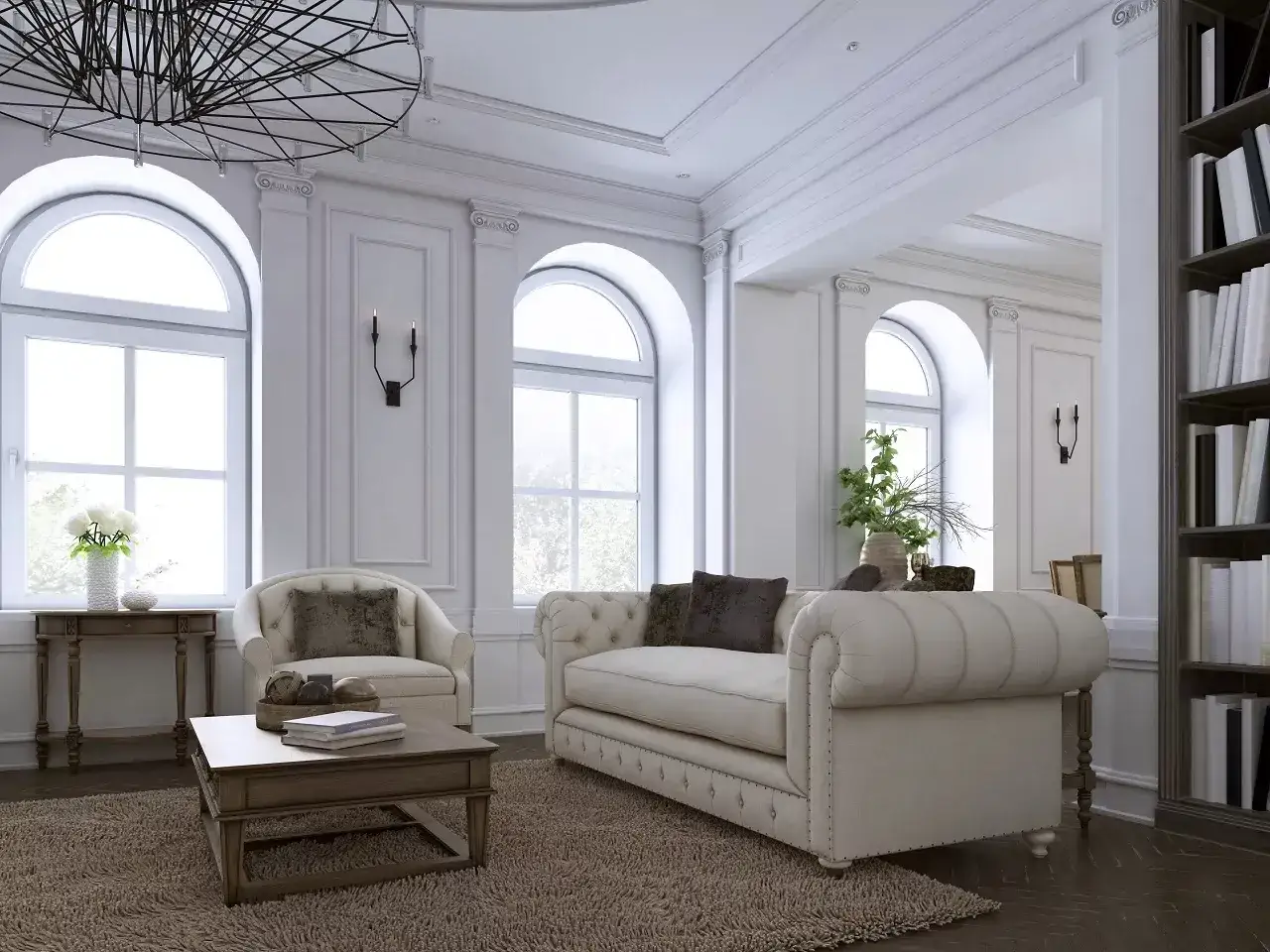 Elegancki salon z sofą, fotelem i książkami na półce.