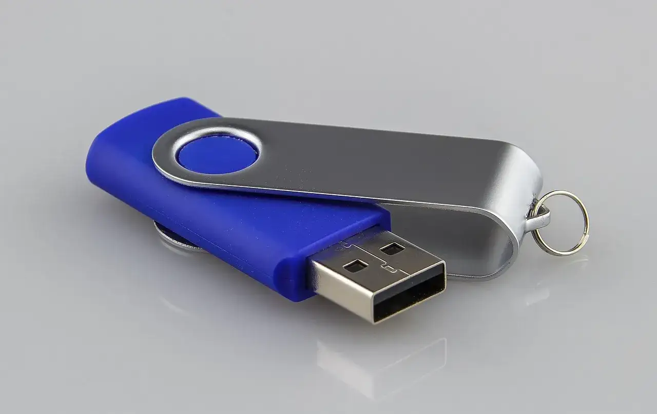 Niebieski pendrive z metalową obrotową osłoną i kółkiem na breloczek.