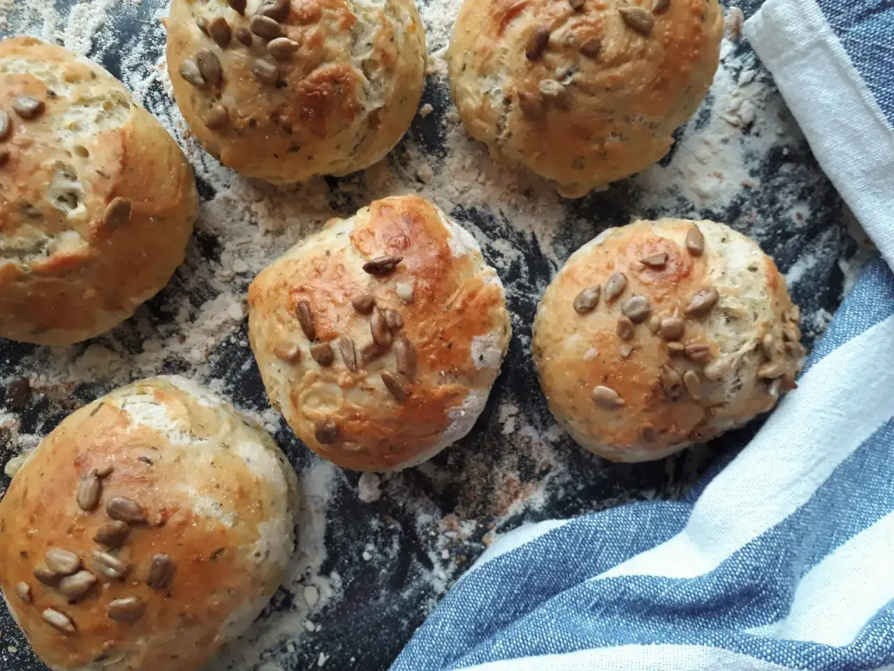 Sześć świeżych bułek do hamburgerów posypanych słonecznikiem, gotowych do tego, jak podgrzać bułki do hamburgerów w airfryer.