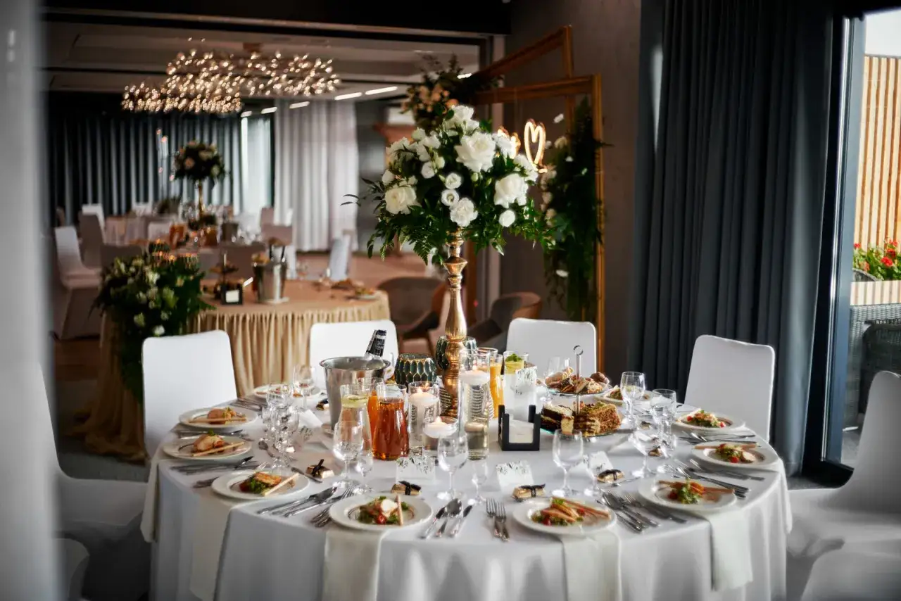 Eleganckie wesele w stylu glamour z bogatymi dekoracjami i kwiatami, kontrastujące z nowoczesnym minimalizmem.