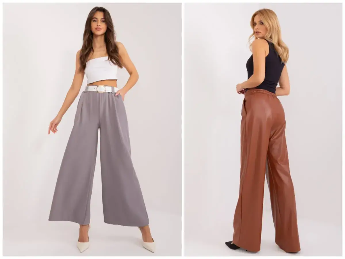 Dwie kobiety prezentują modne stylizacje z szerokimi spodniami. Jedna w szarych, lejących się spodniach i białym topie, druga w brązowych, skórzanych spodniach i czarnym topie.