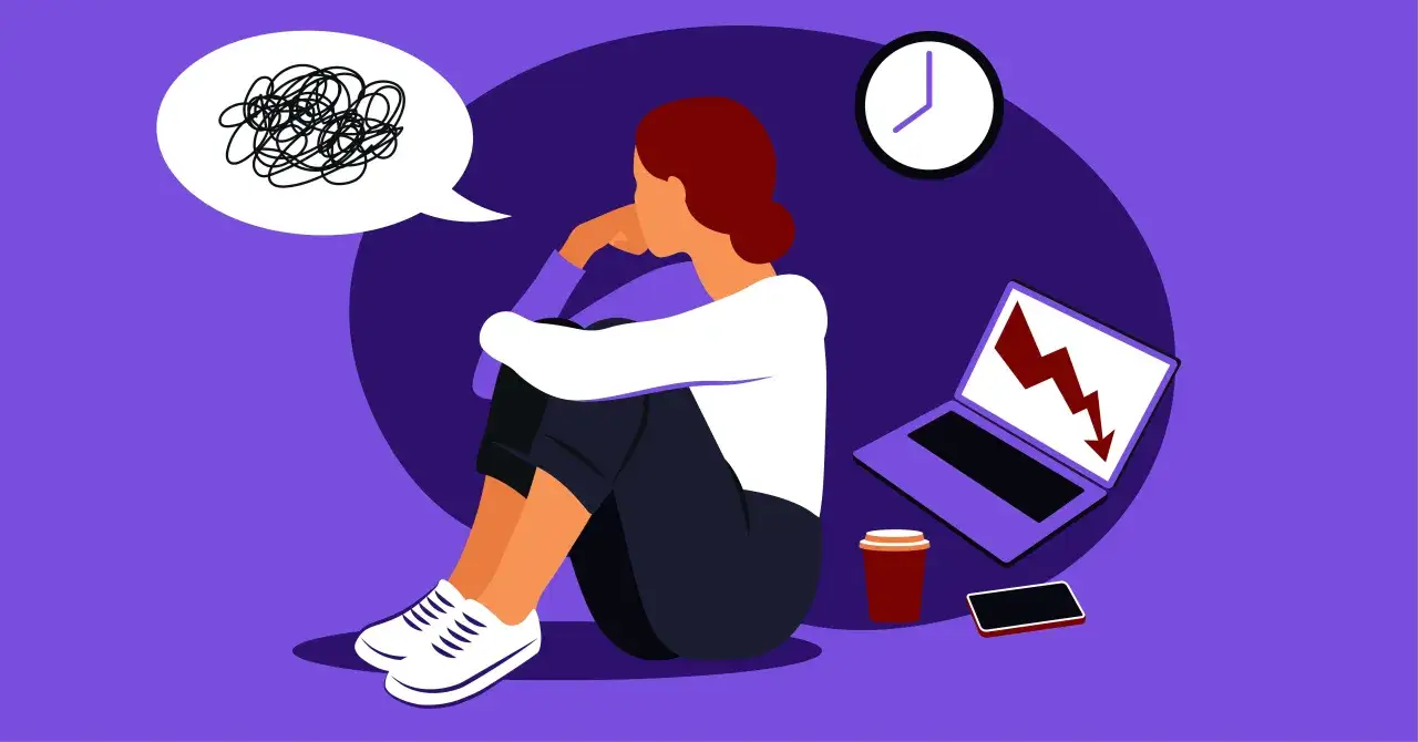 Kobieta siedzi przygnębiona, myśląc o tym, jak walczyć z wypaleniem zawodowym. Obok niej laptop z wykresem spadkowym, zegar i kawa.