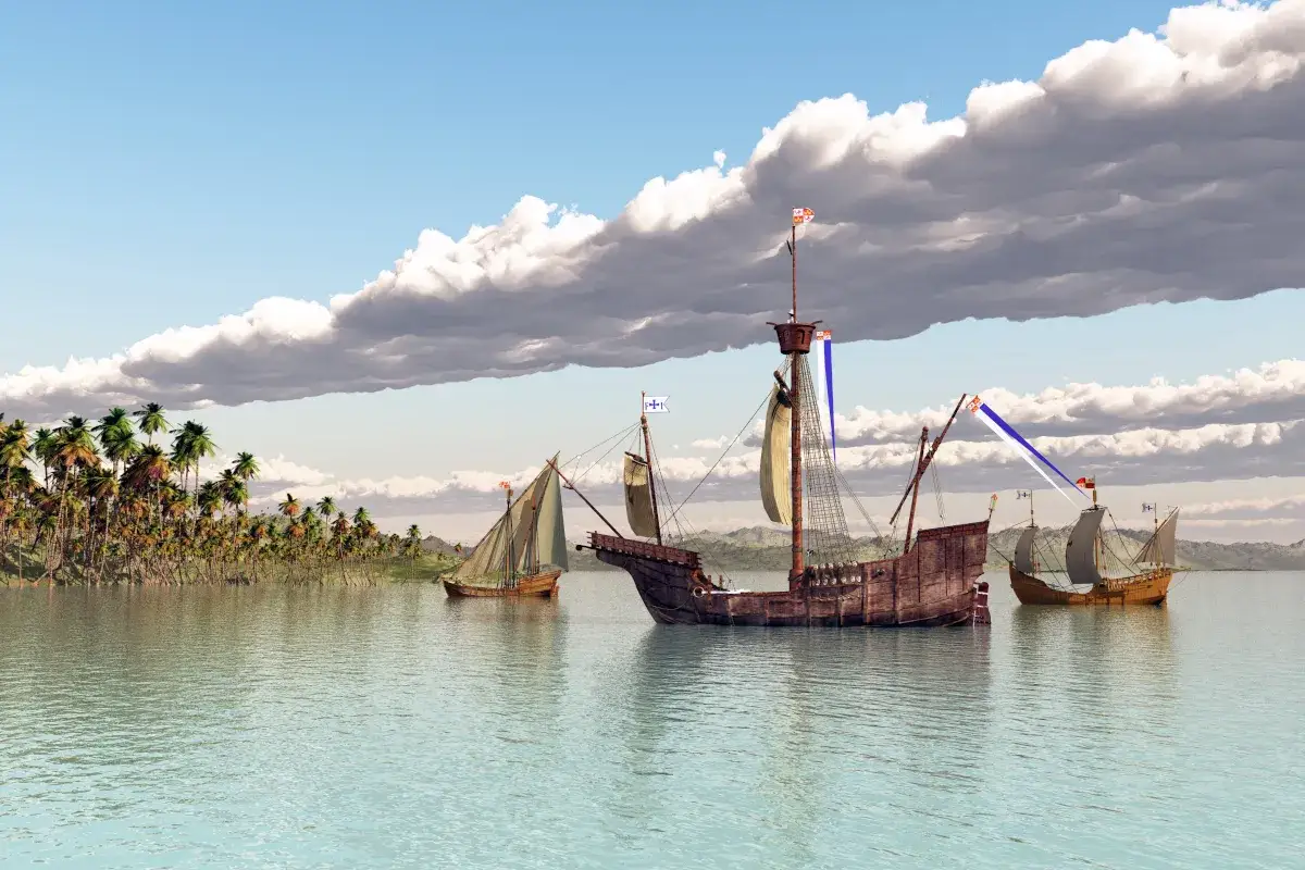 Trzy żaglowce zbliżają się do tropikalnej wyspy, przypominając moment, kiedy Kolumb dotarł do Ameryki.