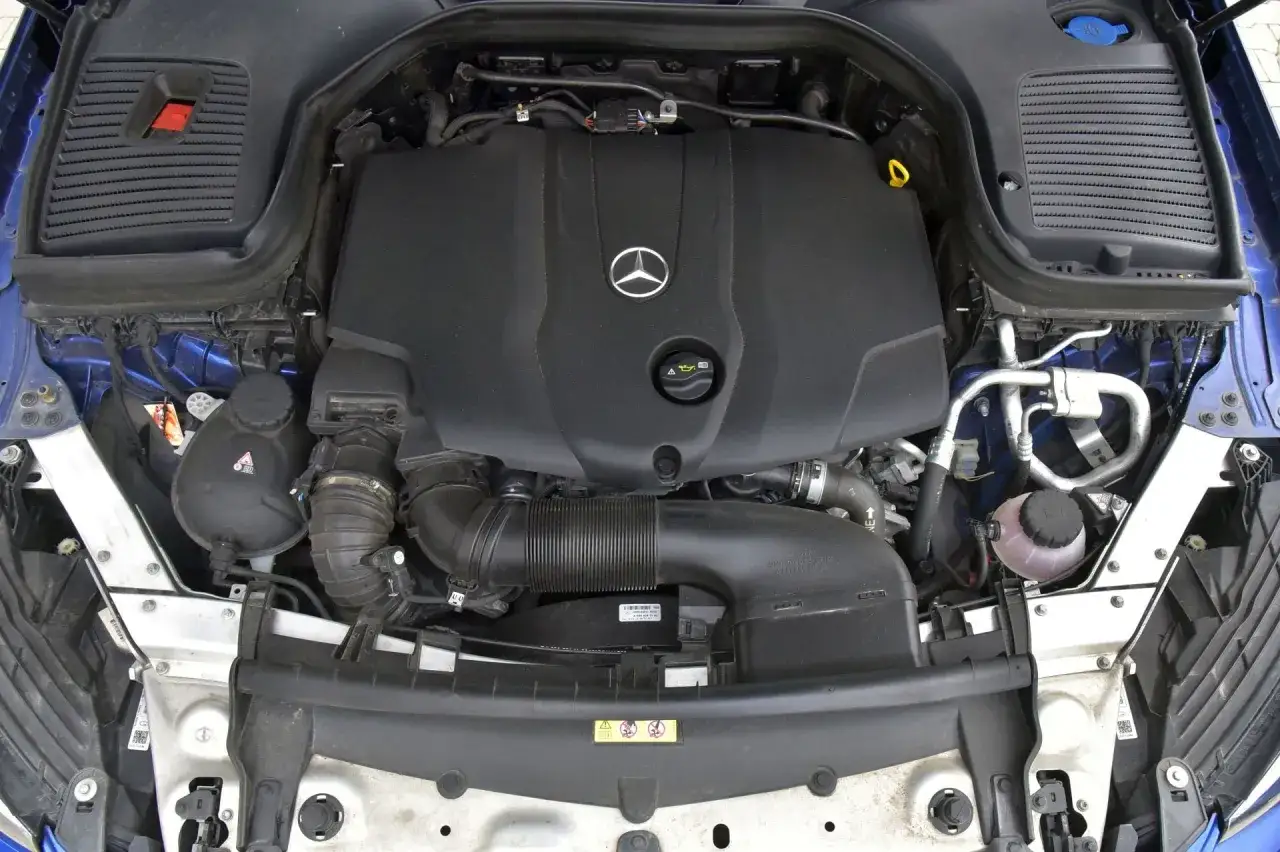 Silnik Mercedesa GLC 200 4Matic. Widoczny czarny, plastikowy kolektor dolotowy i inne elementy pod maską.