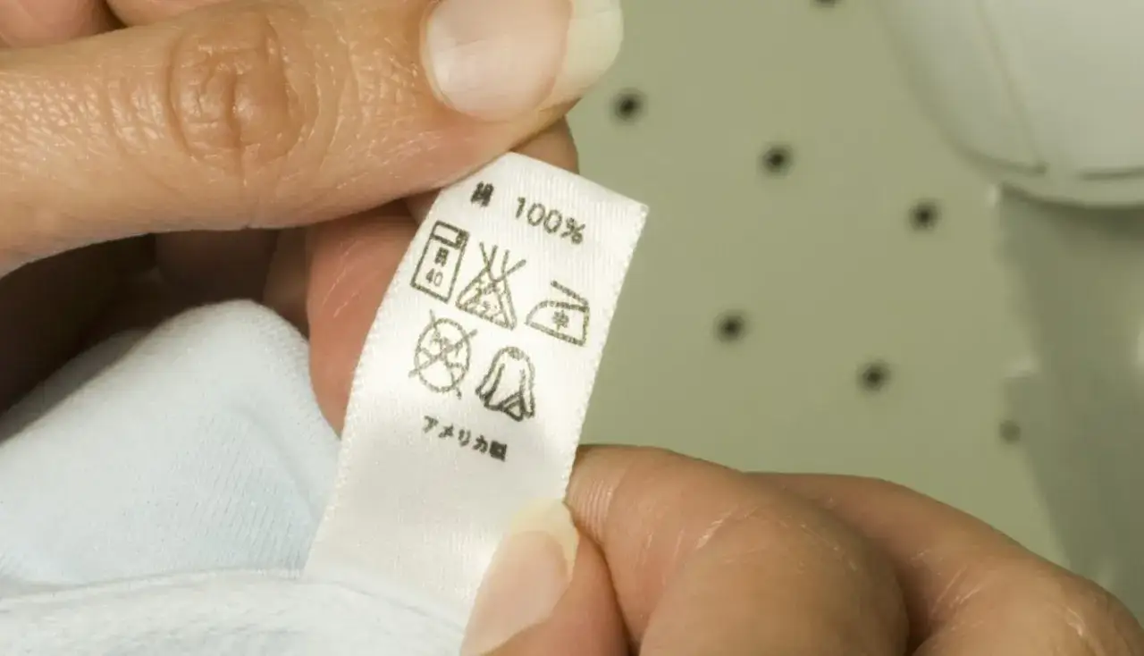 kobieta sprawdzająca metkę na ubraniu w zbliżeniu