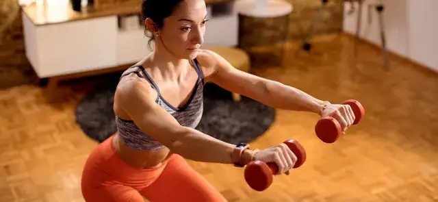 trening siłowy z hantlami, kobieta ćwicząca na siłowni