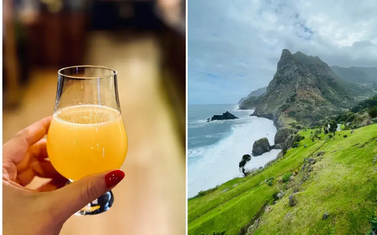 Szklanka z bursztynowym płynem, być może rum z Madery, na tle malowniczego, zielonego wybrzeża z klifami i wzburzonym oceanem.