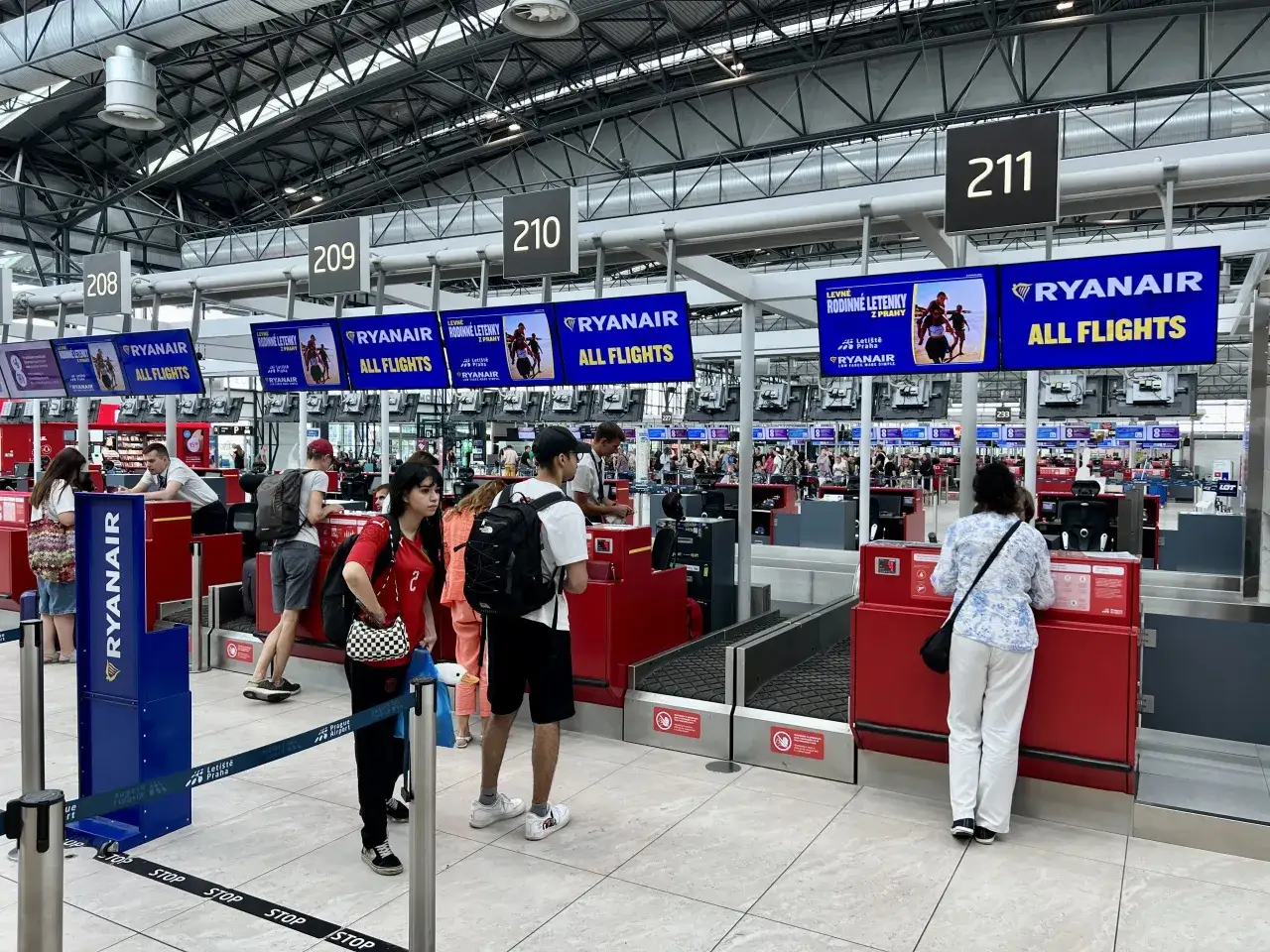 Kasa Ryanair na lotnisku. Zastanawiasz się, ile wcześniej trzeba być na lotnisku Ryanair? Ludzie czekają w kolejce.