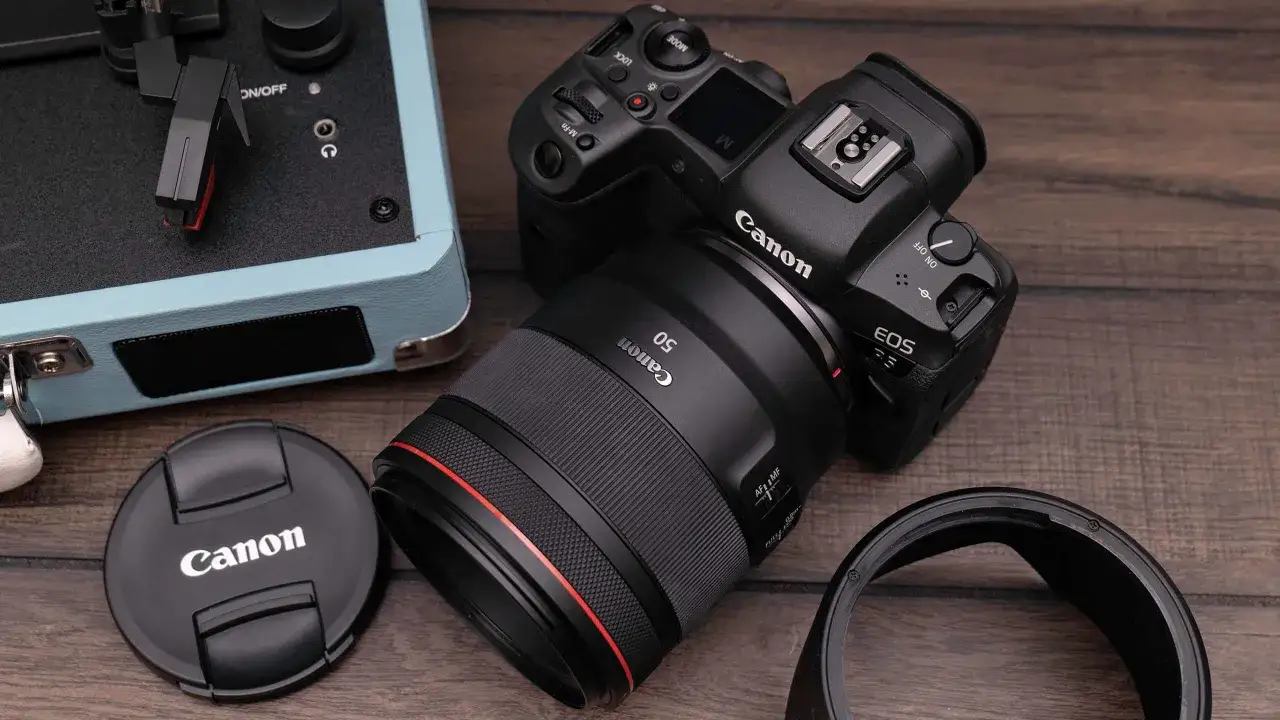 professional photographer with Canon camera and red ring L-series lens