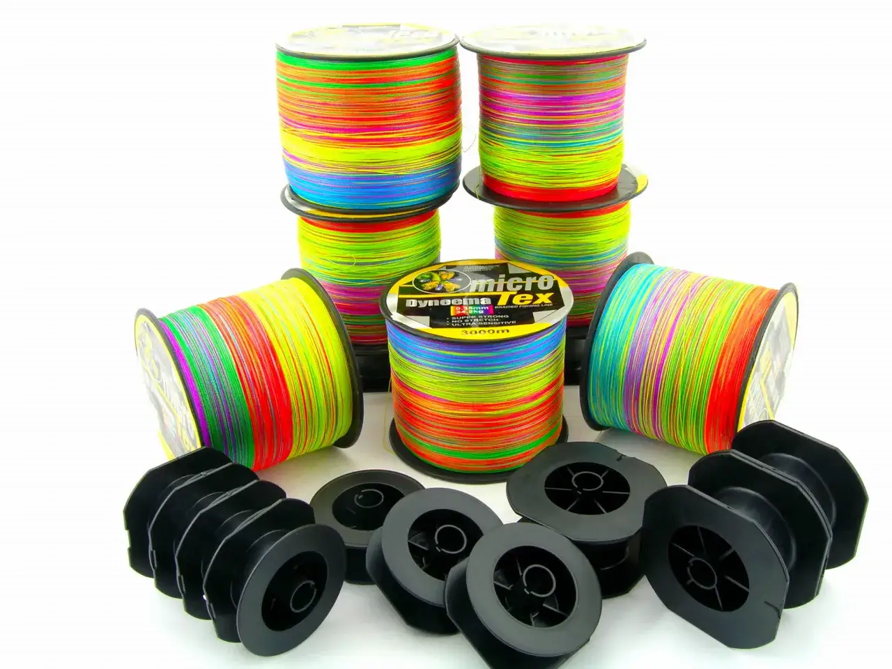 Różne grubości plecionek wędkarskich na tle miarki