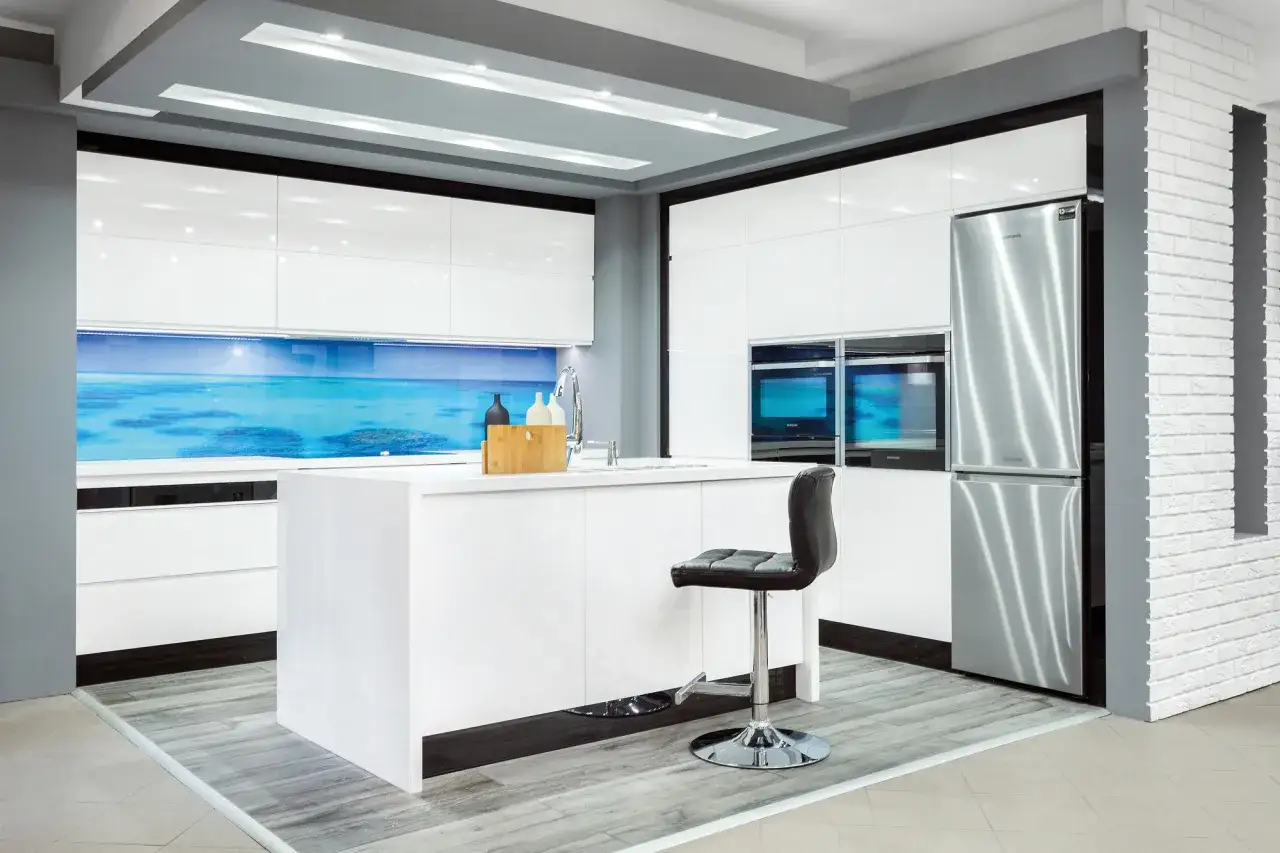 Nowoczesna kuchnia z białymi frontami, lodówką Samsung i panelem ze zdjęciem rafy koralowej – świetna alternatywa co zamiast płytek w kuchni.