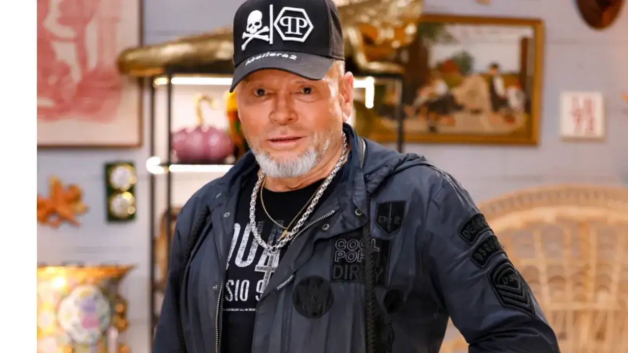Krzysztof Rutkowski, znany detektyw, w czapce z czaszką i bogatym łańcuchem. Jego wiek zdradza siwa broda.