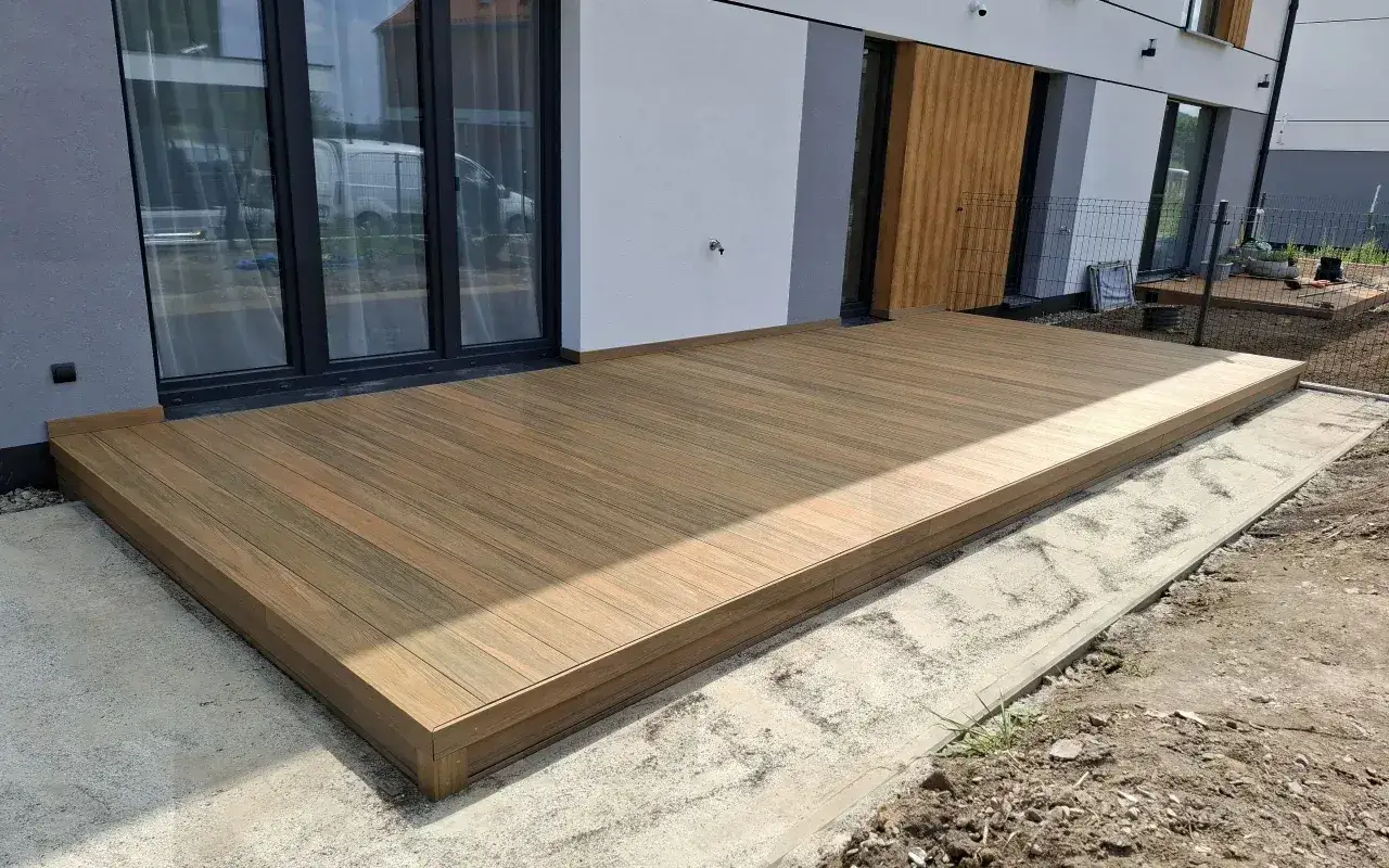 Nowy taras z desek kompozytowych, gotowy do użytku. Dowiedz się, jak zbudować taras i ciesz się relaksem na świeżym powietrzu.