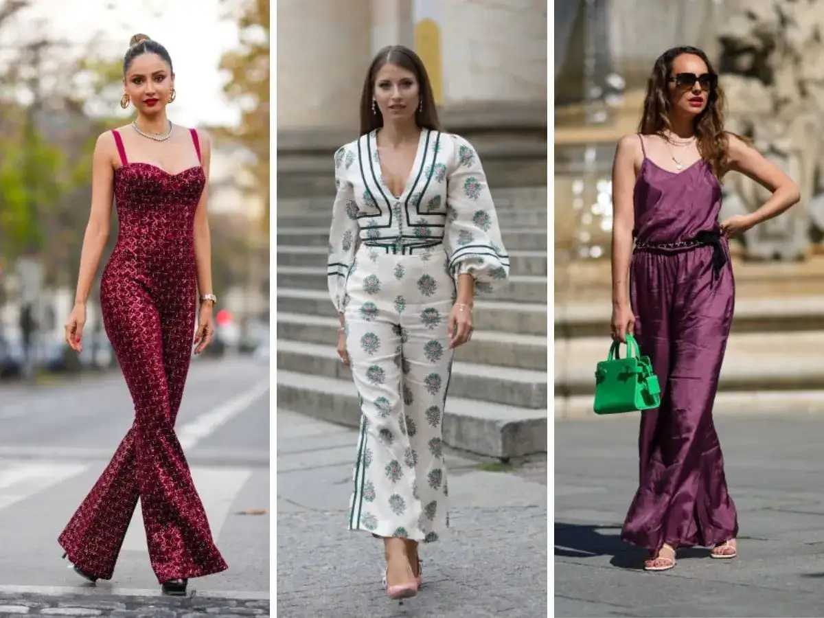 Trzy kobiety w eleganckich kombinezonach. Jedna w bordowym, błyszczącym, druga w białym z kwiatowym wzorem, trzecia w fioletowym satynowym. Wszystkie mają stylowe buty do kombinezonu.