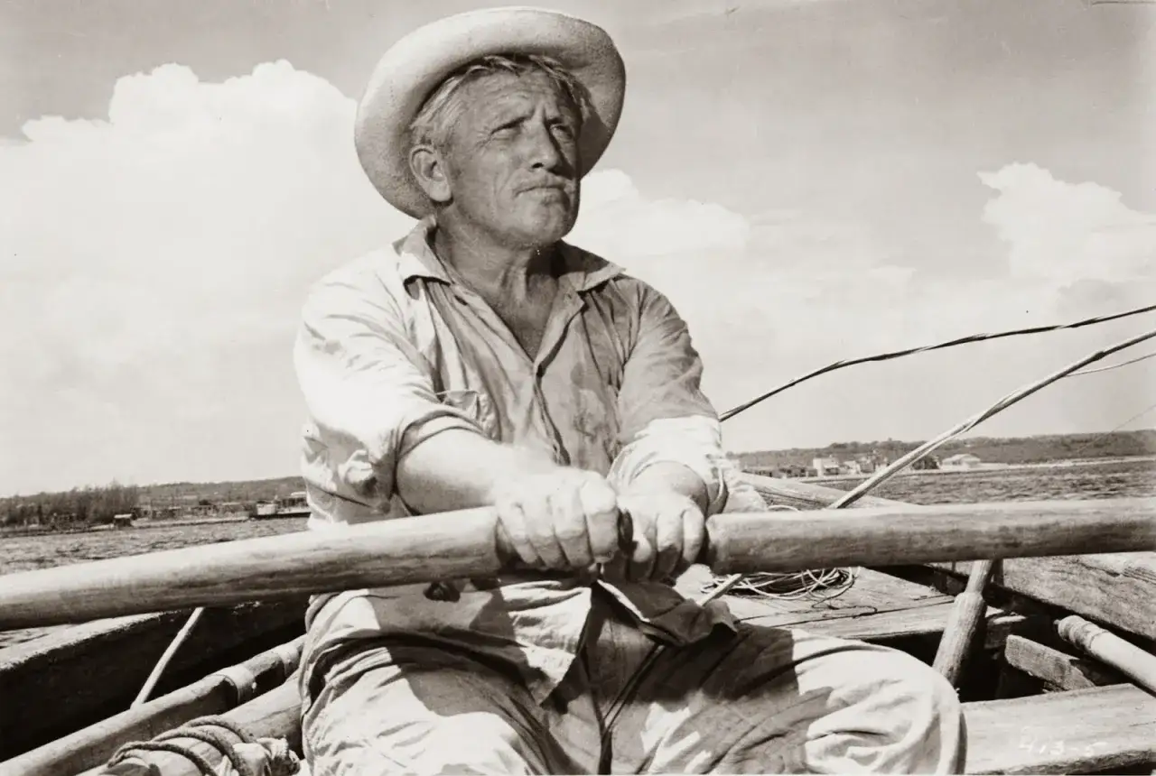 Stary człowiek i morze bohaterowie: Santiago, zmagający się z żywiołem, wiosłuje w swojej łodzi, walcząc o przetrwanie.