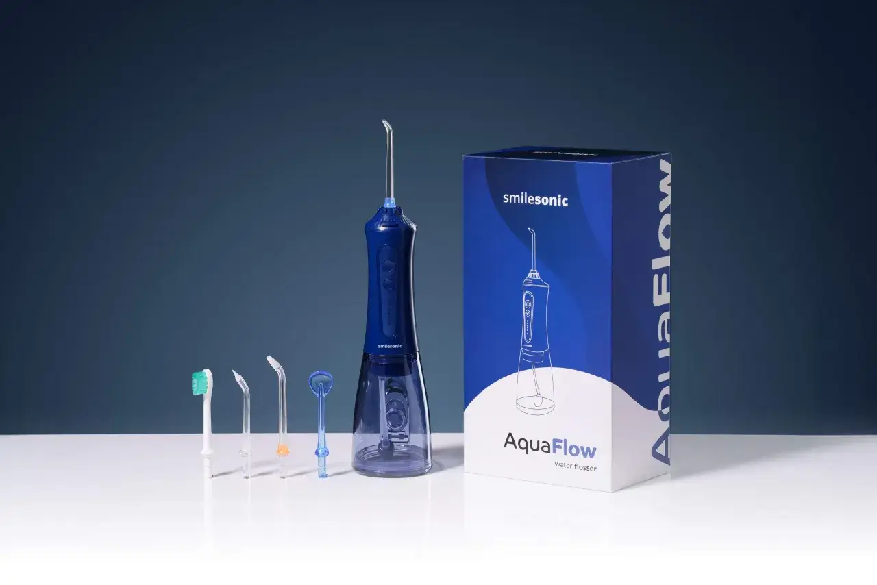 Zestaw do higieny jamy ustnej: niebieski irygator Smilesonic AquaFlow z kilkoma końc&oacute;wkami i opakowaniem. Dowiedz się, jak używać irygatora dla zdrowego uśmiechu.