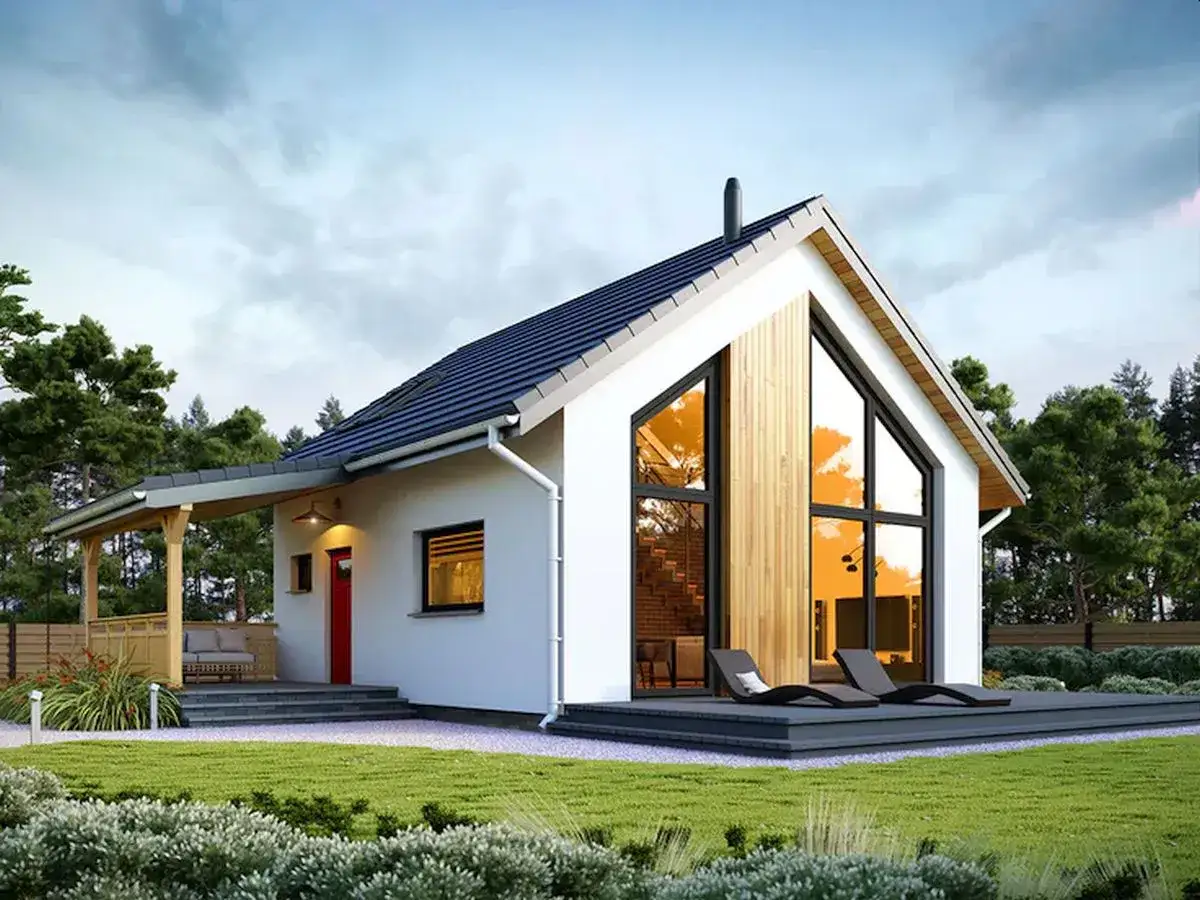 Nowoczesny dom z dużymi oknami i tarasem, idealny przykład, jak zbudować dom marzeń.