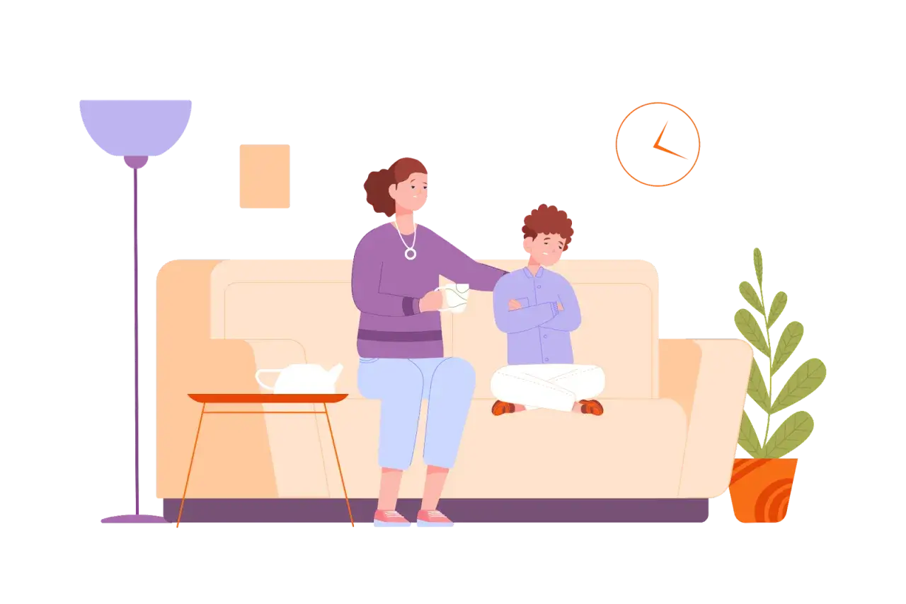 Matka uspokaja syna, który siedzi z założonymi rękami. Rozmowa z dzieckiem o złym zachowaniu wymaga cierpliwości.