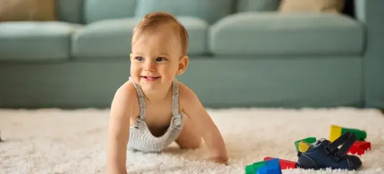 8 miesięczne niemowlę bawi się klockami raczkuje