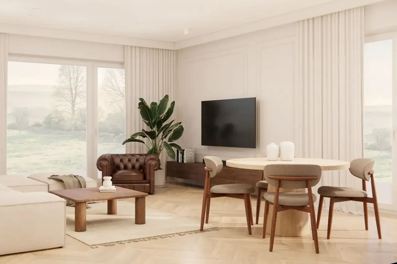 Jasny salon z wygodną sofą, sk&oacute;rzanym fotelem i jadalnią. Duże okna wychodzą na zielony krajobraz. To elegancki dom.