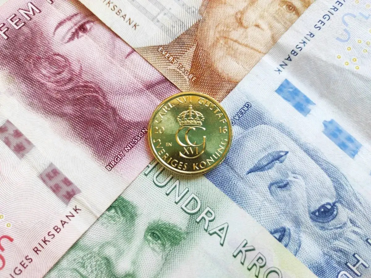 Złota moneta z koroną i napisem 