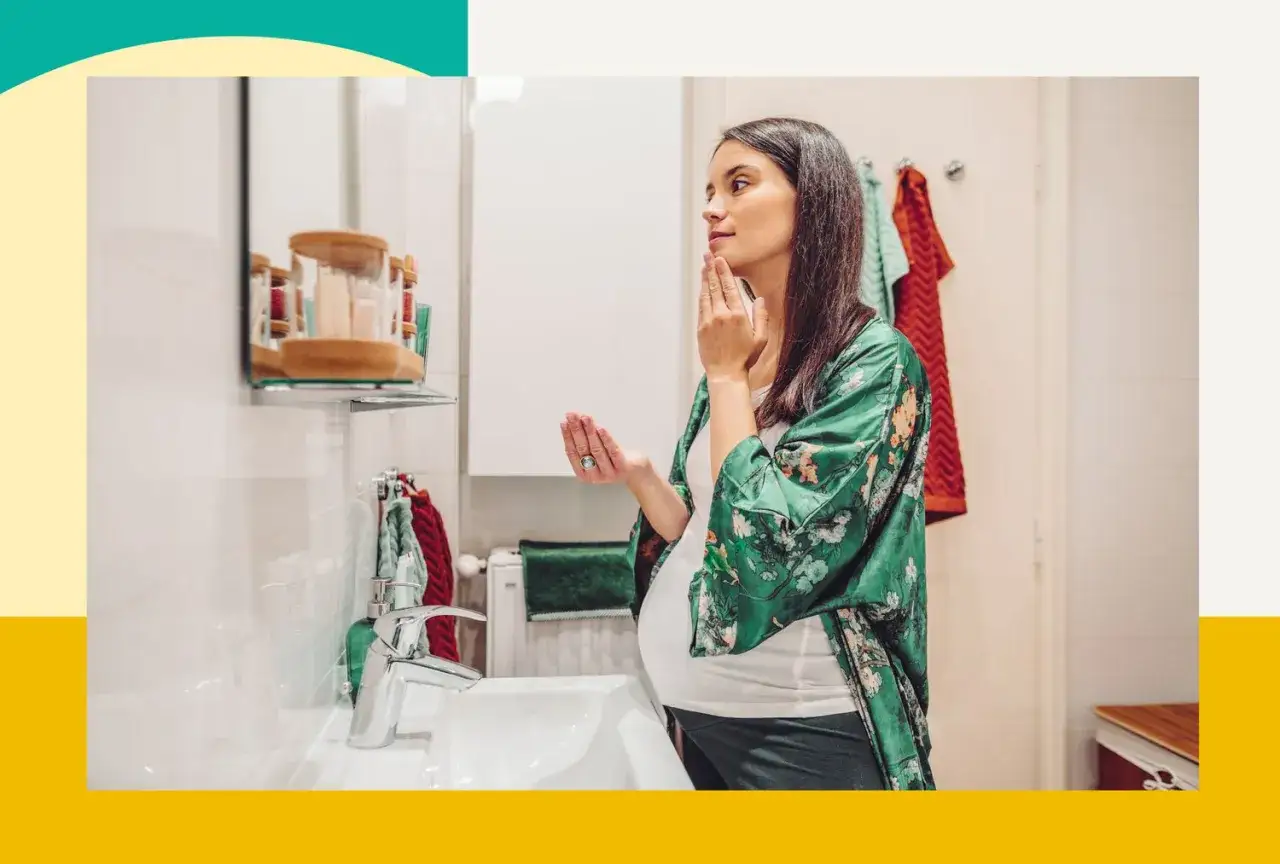 Kobieta w ciąży delikatnie dotyka twarzy, zastanawiając się nad bezpiecznym stosowaniem kwasu salicylowego w pielęgnacji.