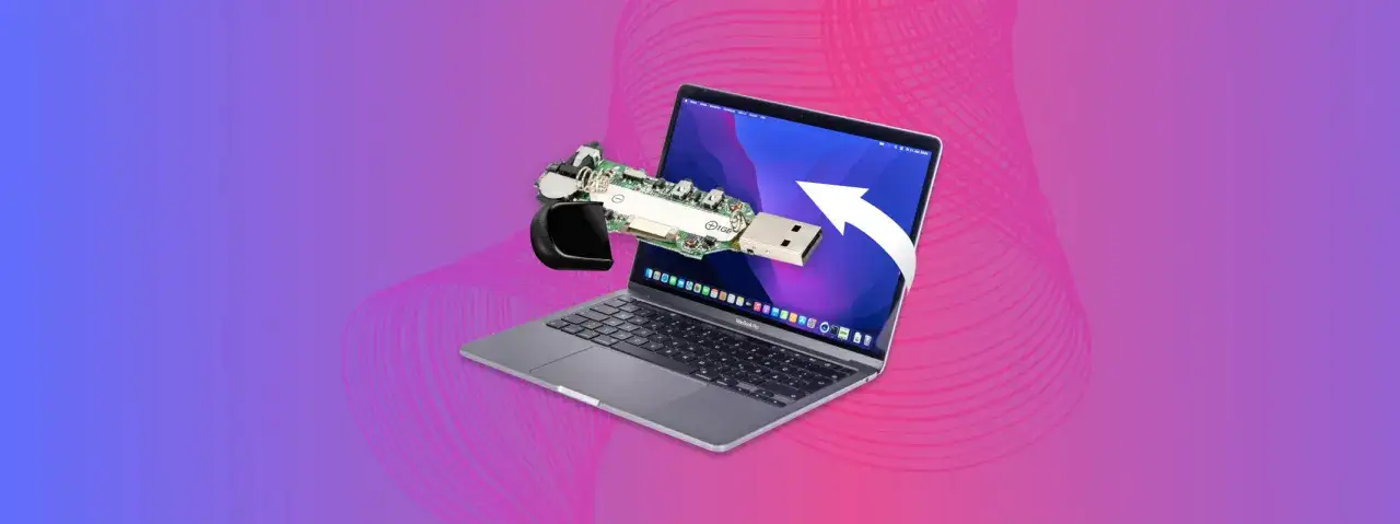 MacBook nie widzi pendrive? Rozłożony pendrive obok laptopa, sugeruje problem z połączeniem.