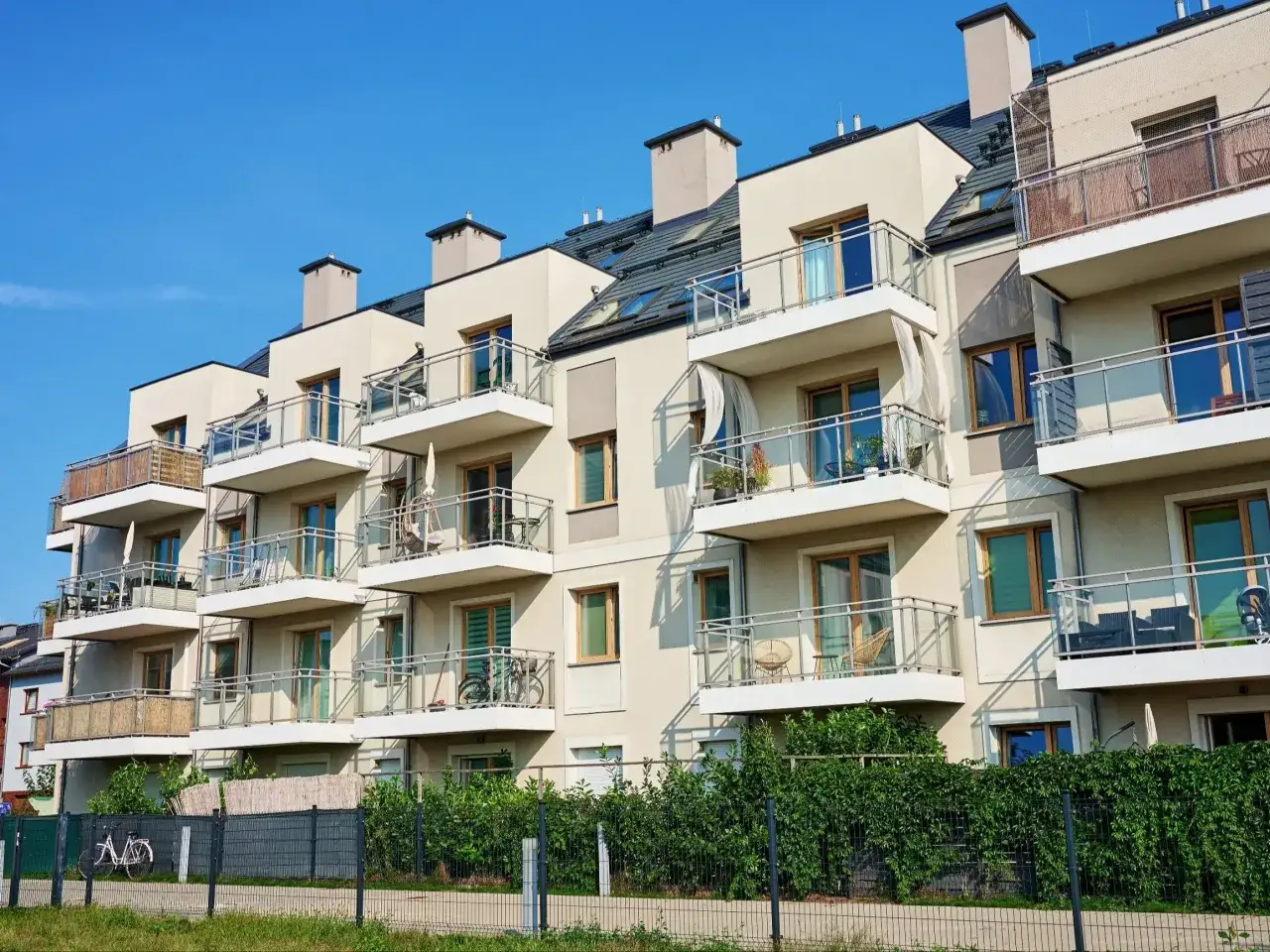 Nowe przepisy od marca 2026: wspólnoty mieszkaniowe mogą nakładać wyższe kary za najem. Nowoczesne bloki z balkonami.