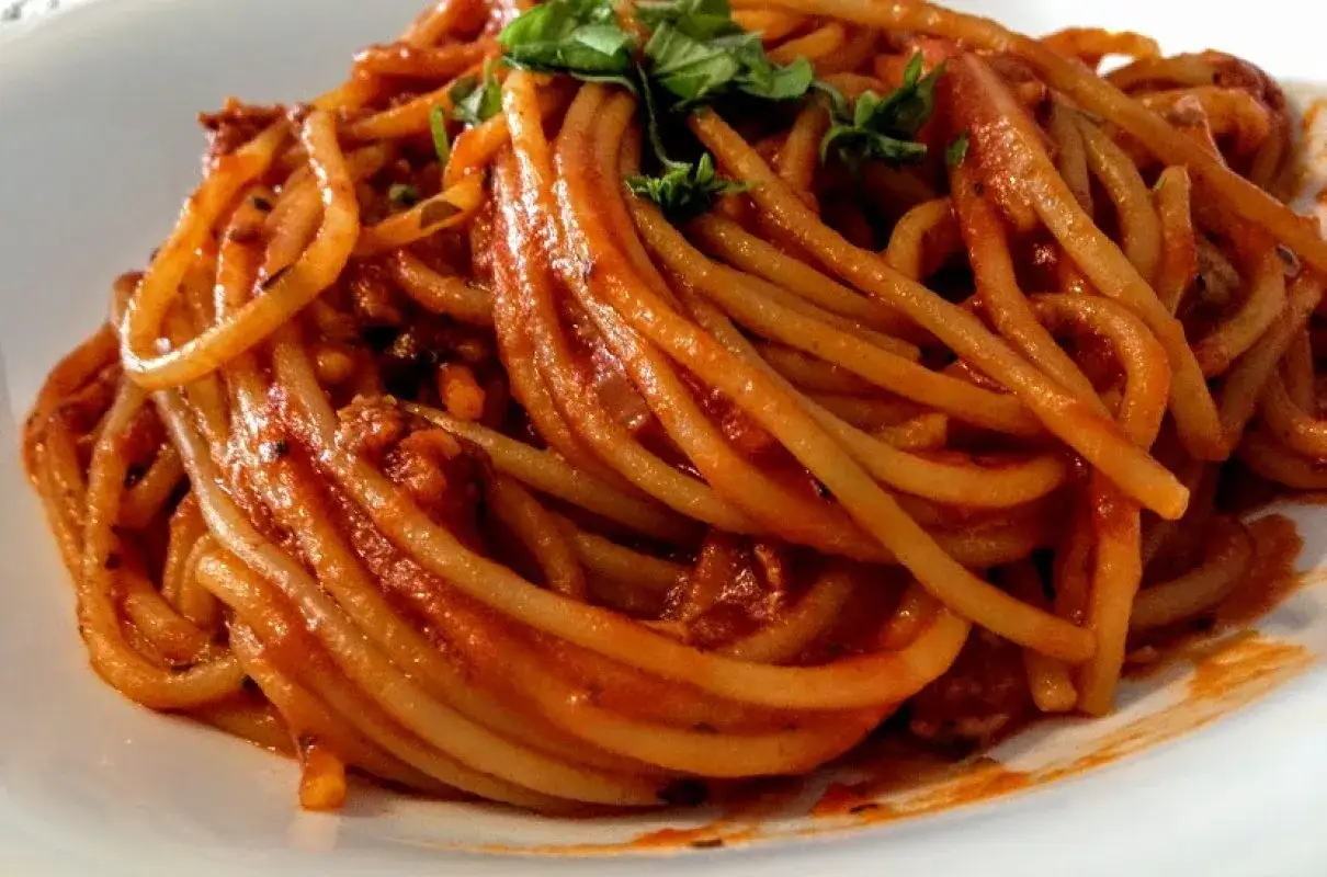 Pyszne spaghetti bolognese z aromatycznym sosem mięsnym i świeżą bazylią. Idealny pomysł, co zrobić z makaronem spaghetti na obiad.