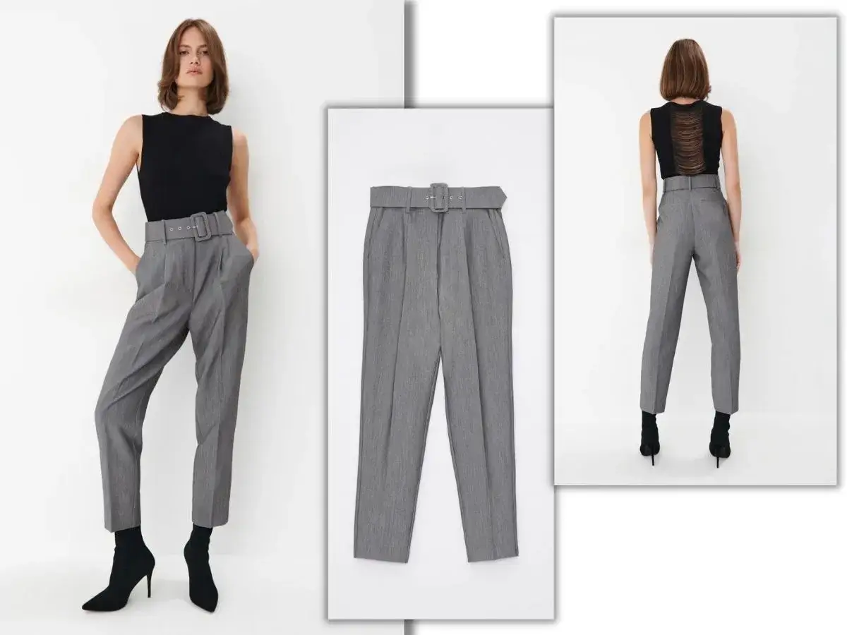 Eleganckie spodnie damskie, szerokie w udach, zwężające się ku dołowi, z wysokim stanem i paskiem.