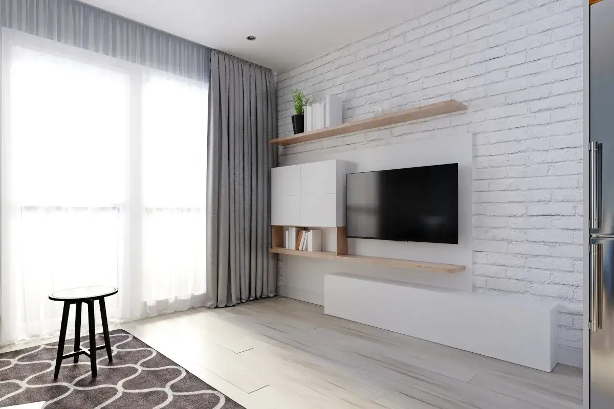 Nowoczesne telewizor na ścianie aranżacje: biała cegła, drewniane półki i minimalistyczna zabudowa tworzą przytulną przestrzeń.