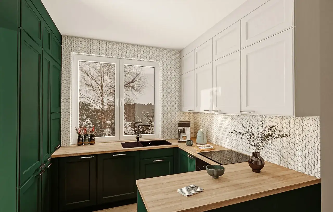 Nowoczesna kuchnia z ciemnozielonymi szafkami i białymi górnymi. Okna w kuchni są na standardowej wysokości, wpuszczając zimowy widok.