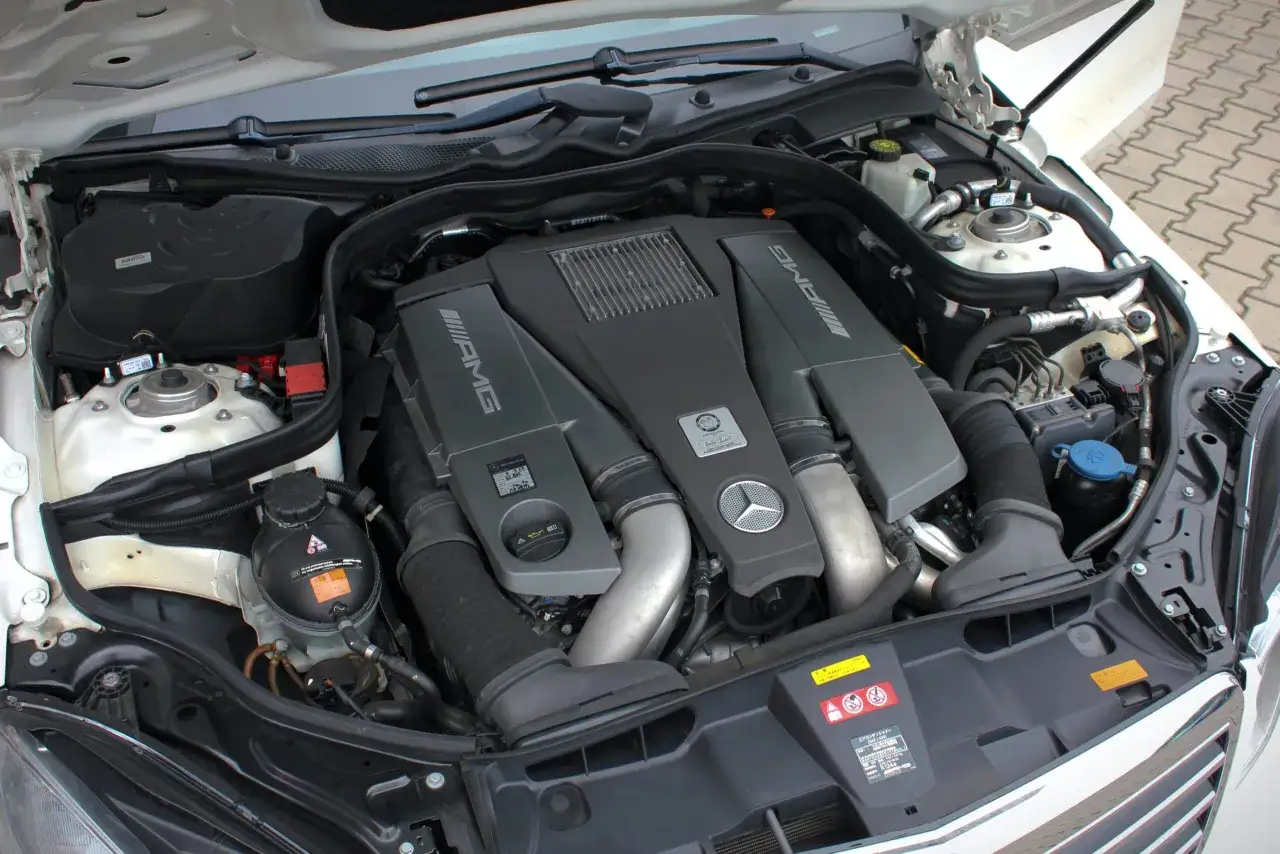 Silnik V8 AMG w Mercedes-Benz E63 AMG, z widocznymi turbosprężarkami i charakterystycznym logo.