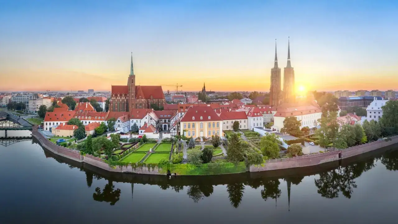 Wrocław co zobaczyć w 1 dzień? Panorama Ostrowa Tumskiego z katedrą i rzeką Odrą o wschodzie słońca. Idealne miejsce na początek zwiedzania.