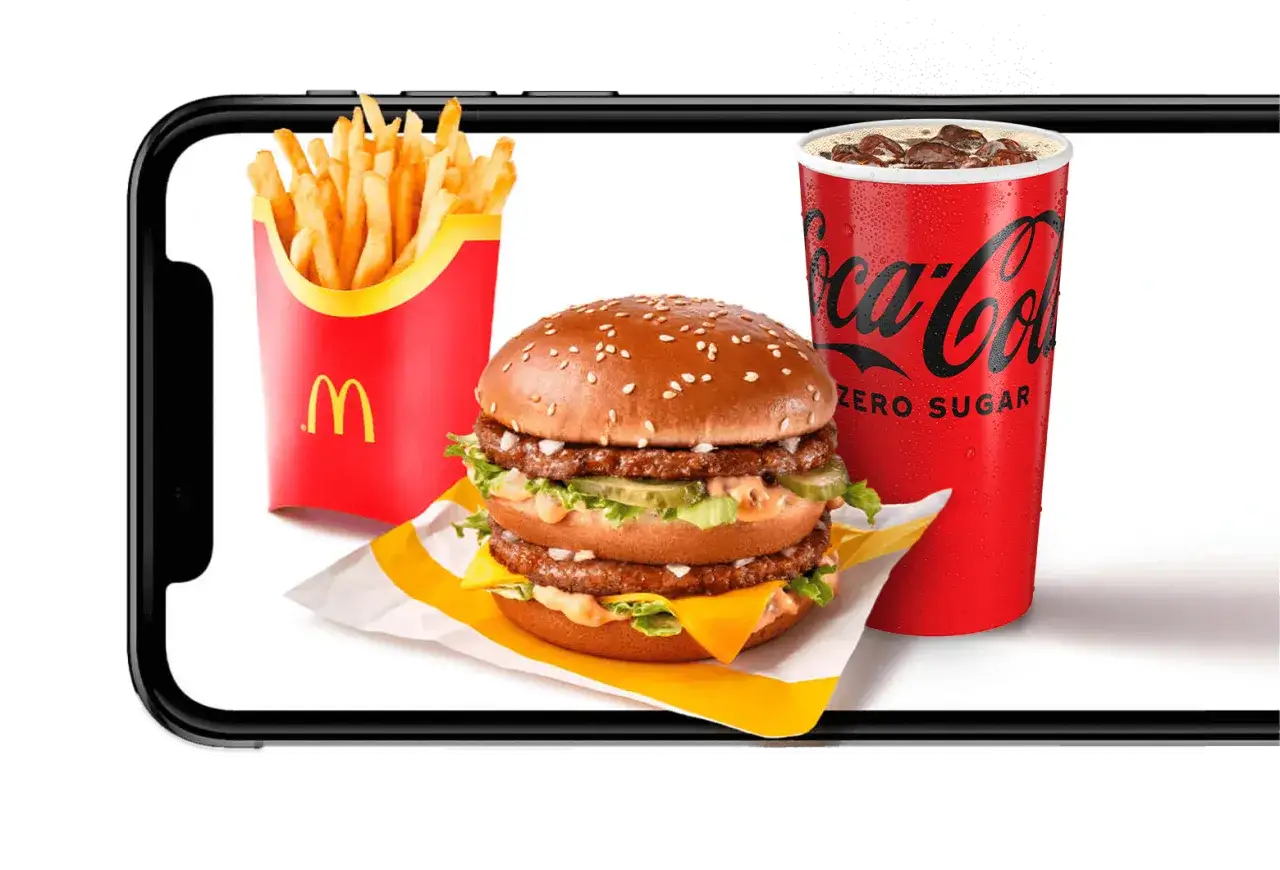 Jak ściągnąć aplikacje McDonald's na telefon? Zobacz Big Maca, frytki i Coca-Colę Zero na ekranie smartfona.