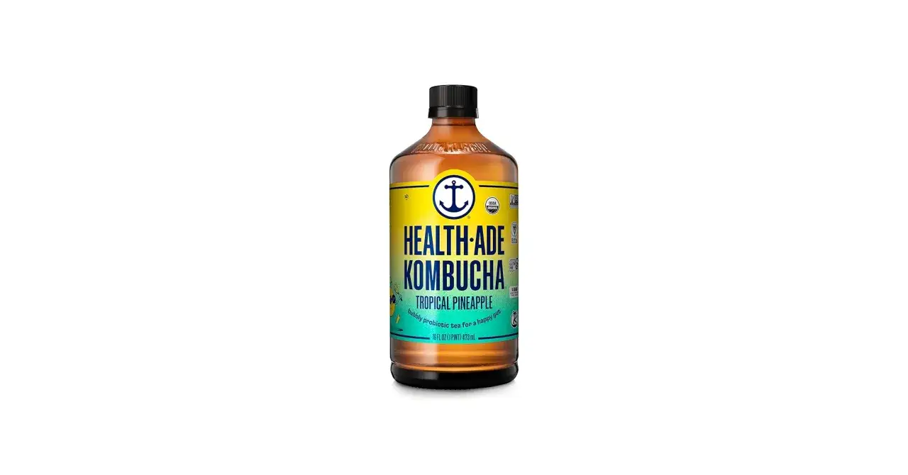 Szklana butelka z napojem Health-Ade Kombucha o smaku Tropical Pineapple. To musująca herbata probiotyczna, kt&oacute;ra jest zdrowa dla jelit.