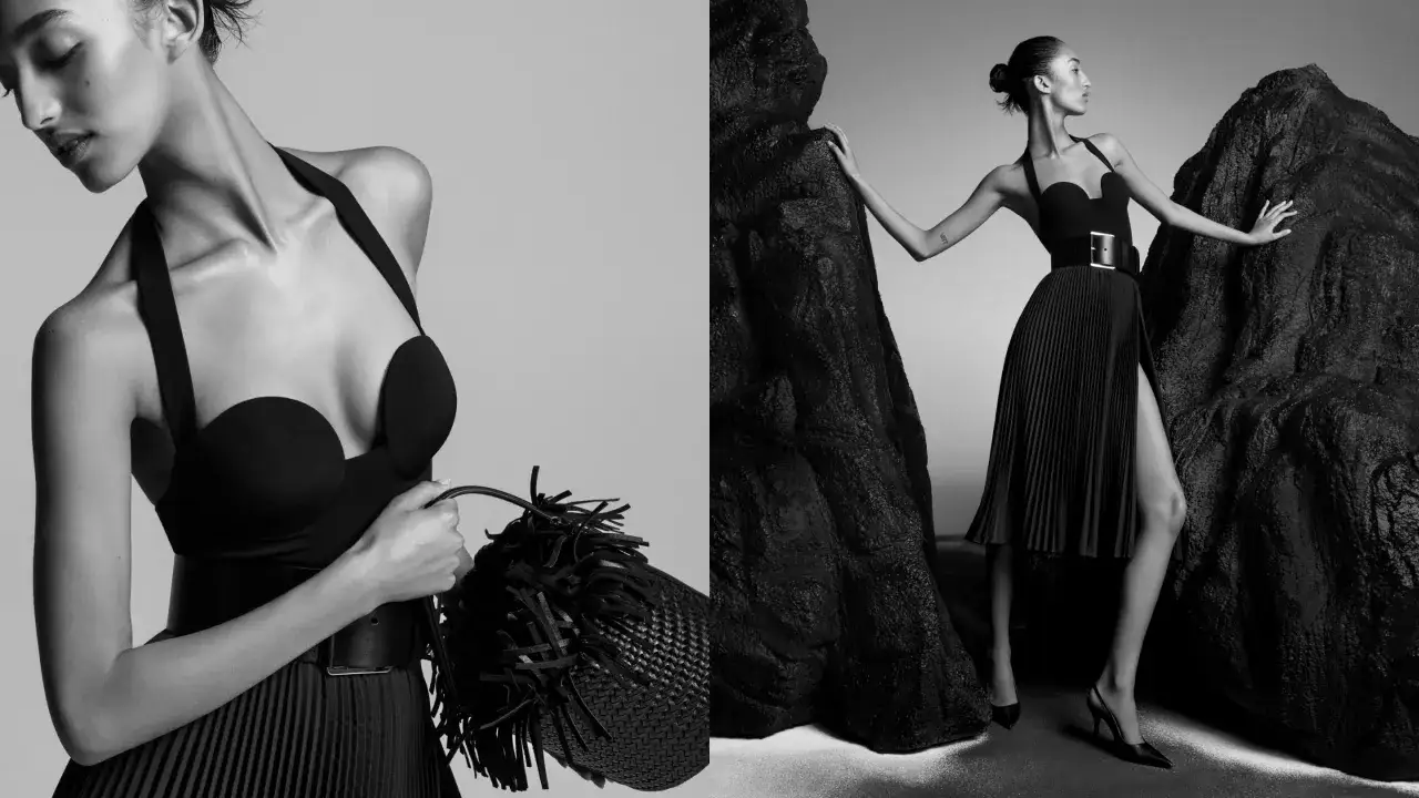 Elegancka kobieta w czarnej sukience i torebce z frędzlami. To kwintesencja stylu Michael Kors – co to za marka? Luksus i nowoczesność.