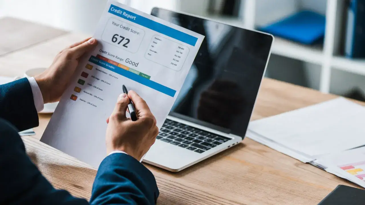 Person checking credit report online or looking at financial documents