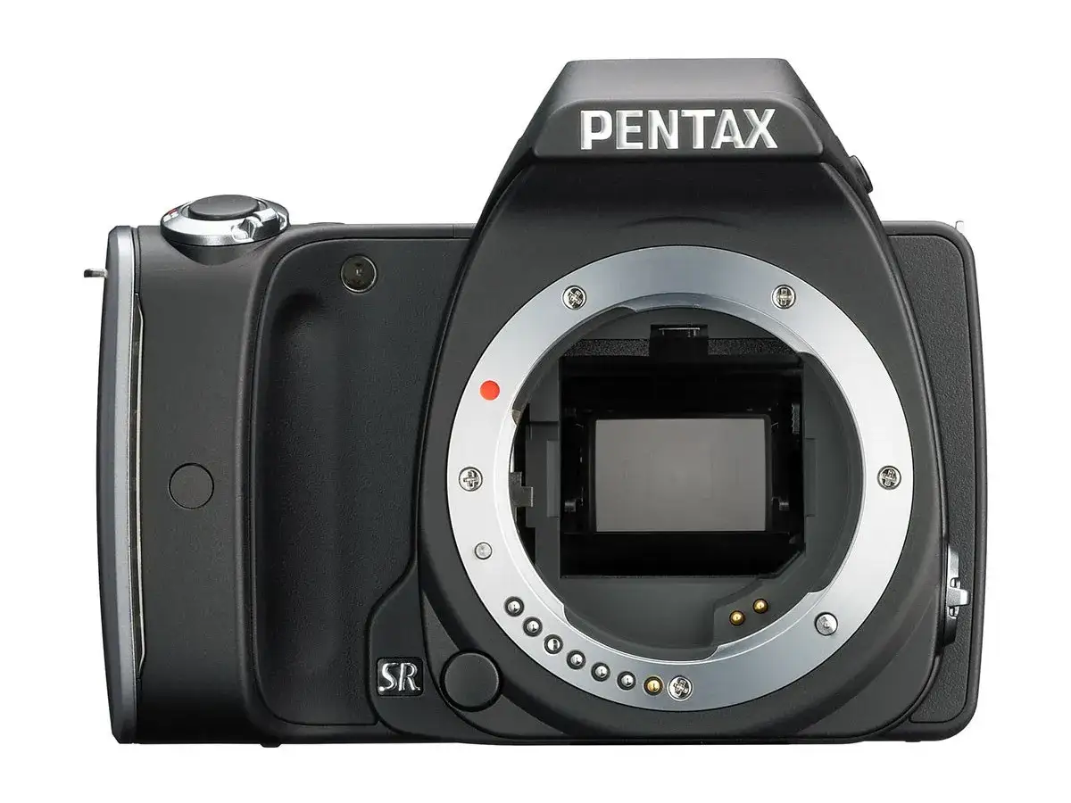 Pentax KM z obiektywem kitowym w rękach amatora