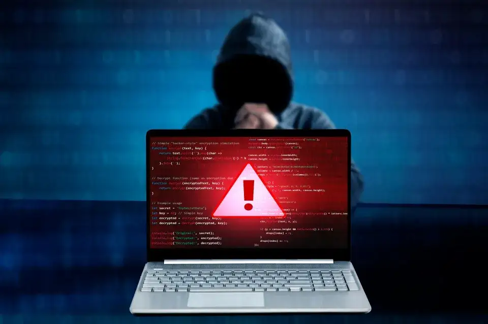 computer screen with spotify and a warning sign