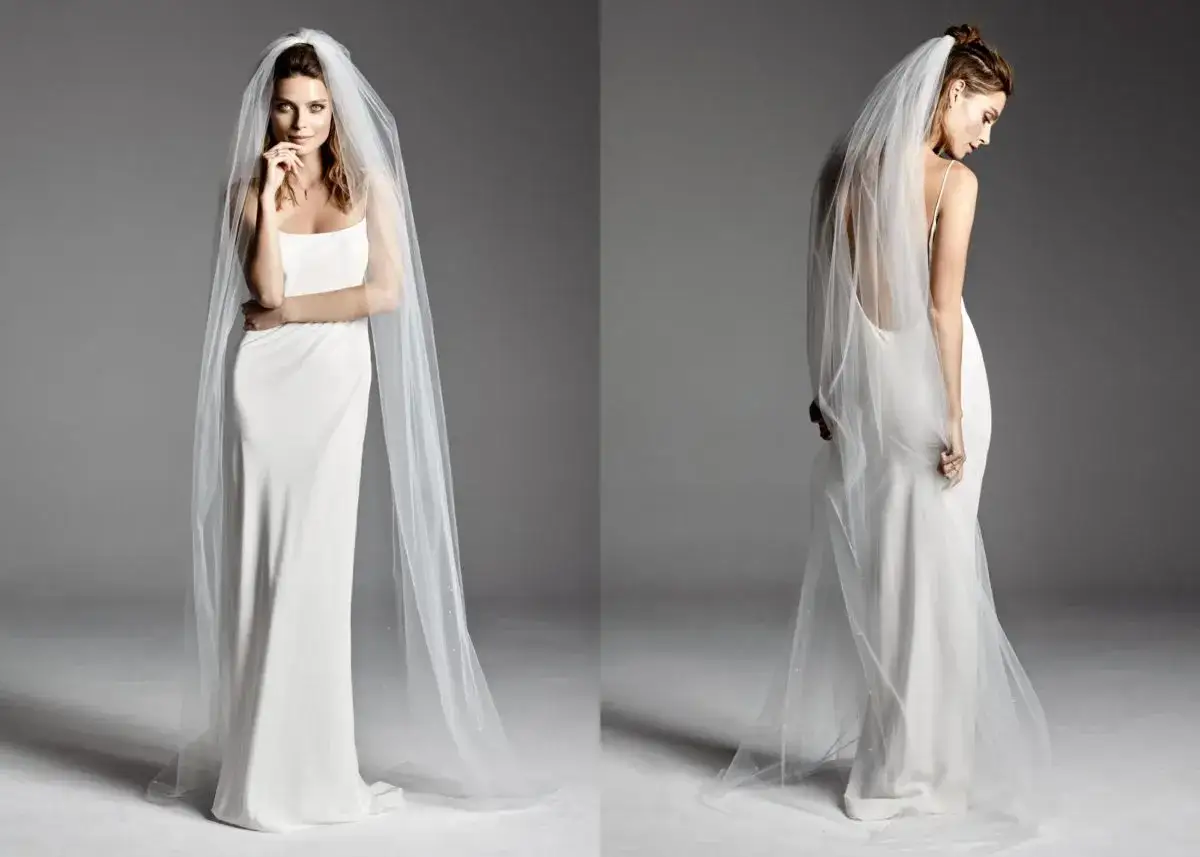 Elegancka suknia ślubna z welonem. Zastanawiasz się, ile kosztuje uszycie sukni ślubnej u krawcowej?