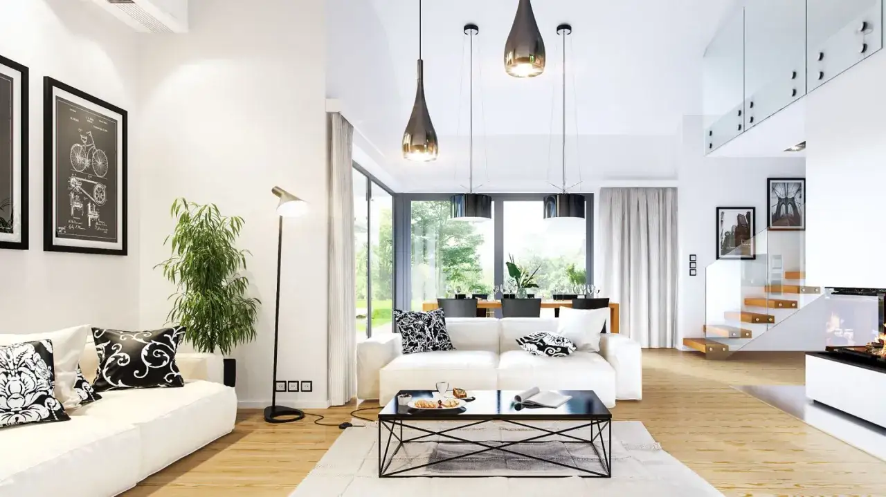Nowoczesne, jasne wnętrze z białymi sofami, czarnym stolikiem i widokiem na ogr&oacute;d. Idealne dla pięknych dom&oacute;w parterowych.