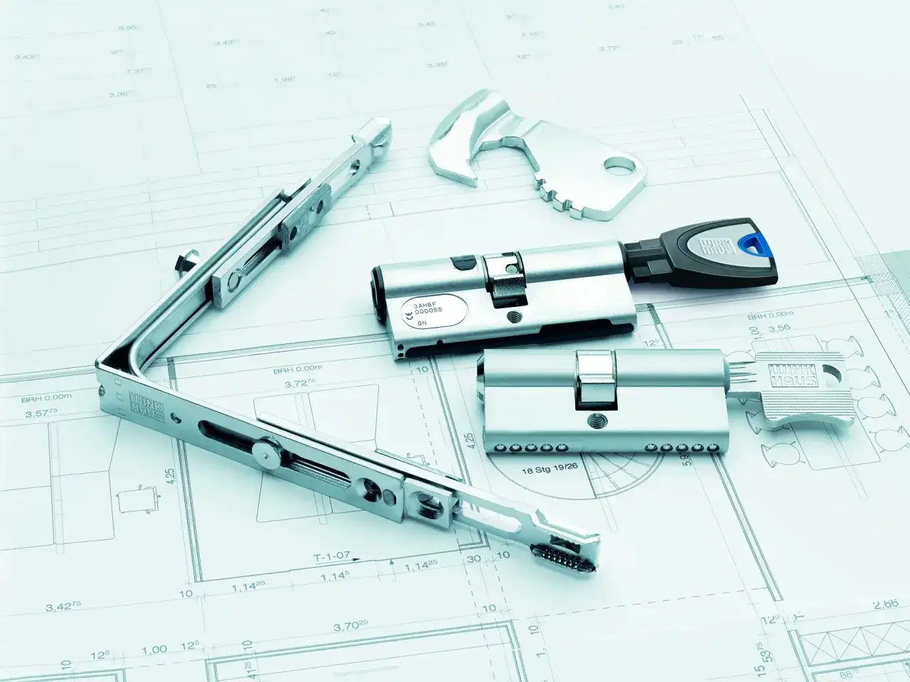 Elementy systemu zabezpieczeń Winkhaus zamek, klucze i mechanizm na tle plan&oacute;w technicznych.