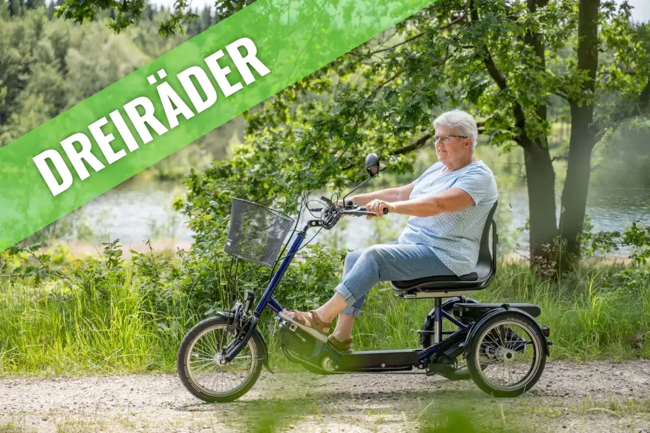 Person f&auml;hrt Dreirad mit Elektromotor