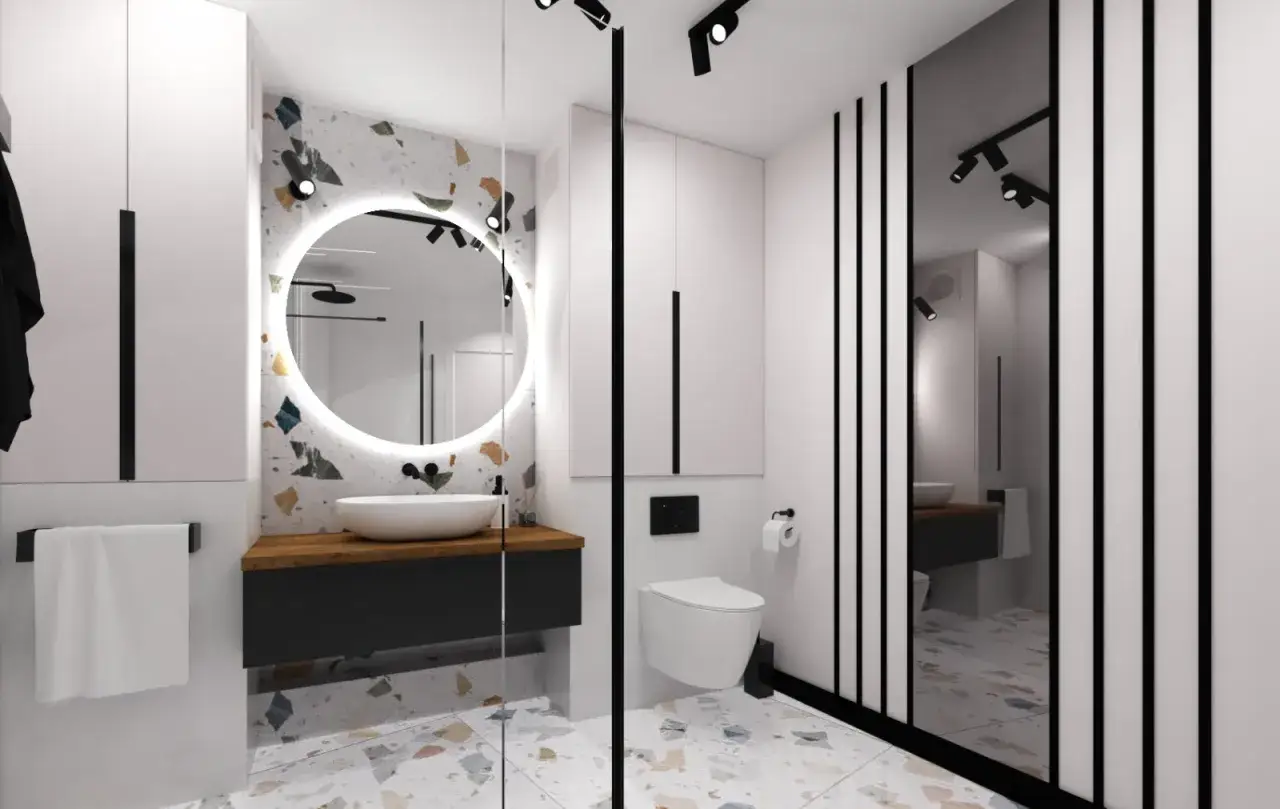 Nowoczesna łazienka z okrągłym lustrem i terazzo. Zastanawiasz się, ile za m2 łazienki robocizna?