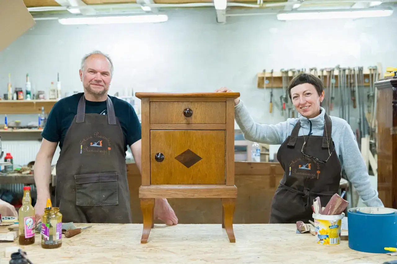 Para prezentuje odnowiony mebel. Ich pasja to renowacja antyków, a efekt ich pracy widać na zdjęciu.